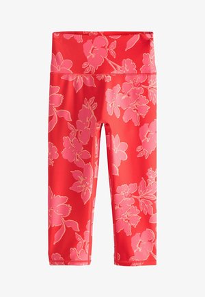 Bright coral high-waist cropped leggings with large pink floral print and flatlock stitching for activewear.
