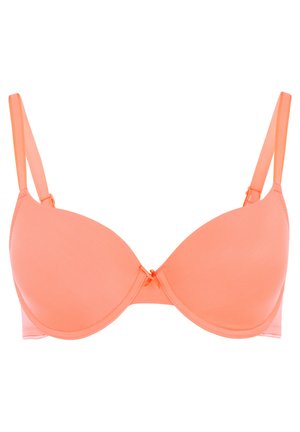 Peach-colored bra with smooth, molded cups, adjustable straps, and a small decorative bow at the center. Lightweight fabric.