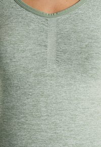 Green heathered tank top featuring a rounded neckline, soft fabric texture, and a subtle knit pattern along the center seam.