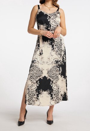 Vestido maxi negro y beige con un diseño de estampado floral y de leopardo, hecho de una tela suave. Tiene tirantes finos y una abertura lateral.