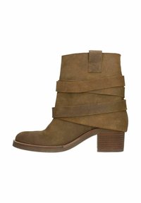 Bottines en daim marron avec un bout arrondi, présentant des bandes diagonales autour de la cheville, un talon bloc et une fermeture éclair sur le côté.