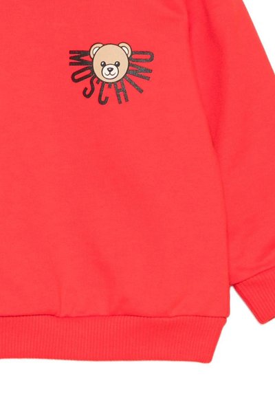 Felpa color corallo con grafica di un orso e il testo "Moschino", cuffie e orlo a costine per una vestibilità aderente. Tessuto morbido e liscio.