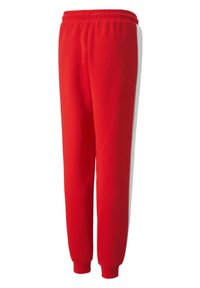 Czerwone dresy z elastycznym pasem, zwężanym krojem nogawki, bocznymi białymi paskami i miękkim bawełnianym materiałem. Brak kieszeni.