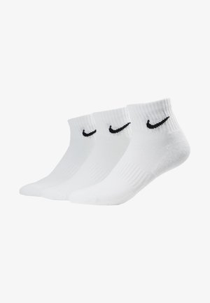 White athletic socks, featuring ribbed texture, mid-calf height, and black Nike swoosh logo on each. Pack of three pairs.