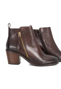 Brown leather ankle boots with a side zip, stacked wooden heel, smooth texture, and pull tab at the back for easy wear.