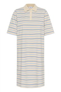 Kreem värvi polo särk, millel on sinised ja mustad horisontaalsed triibud, lühikesed varrukad ja kolme nupuga sild. Valmistatud pehmest ja siledast kangast.