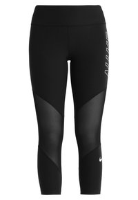 Černé sportovní legíny s průhlednými panely a vysokým pasem. Na levé noze je bílý logotyp a střih je přiléhavý.