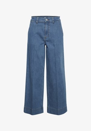 Džínsy s širokými nohavicami v stredne modrej farbe. Vlastnosti zahŕňajú vysoký pás, predné vrecká a viditeľné prešitie. Vyrobené z bavlny s hladkou textúrou.