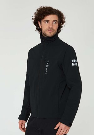 Black softshell jacket with a high collar, front zipper, and zippered chest pocket. Features logo on right sleeve and subtle texture.