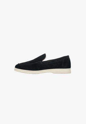 Black suede loafers with a smooth finish, low-profile white rubber sole, and stitched detailing on the upper. Simple, slip-on design.