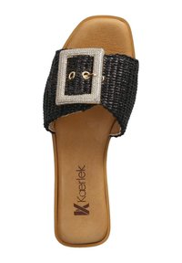 Black woven slide sandal featuring a wide strap with a rectangular rhinestone buckle, tan insole, and flat sole with brand logo.