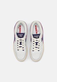 Baskets en cuir blanc avec accents bleu marine et rose. Caractéristiques : embout perforé, lacets plats et semelle en caoutchouc. Logo rouge sur la languette.