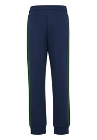 Marina blå sweatpants med gröna sidostråkar, elastisk midja och muddade anklar. Mjuk tyg med en slät yta.