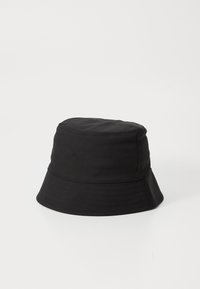 Black cotton bucket hat with a cylindrical crown, wide, downward-sloping brim, and a smooth texture. No patterns or accents.