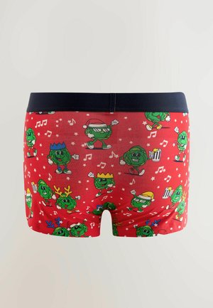 Czerwone bokserki z granatowym pasem, z wzorem kartonowych zielonych warzyw w różnych świątecznych pozach oraz nutami muzycznymi.