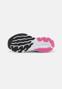 Shoe outsole featuring a textured black and white design with pink accents on the heel and forefoot for improved traction.