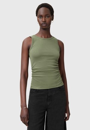 Olive green sleeveless top with a round neck, gathered side detailing, and a smooth cotton texture, paired with black wide-leg trousers.