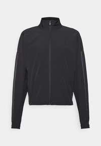Black athletic jacket with a stand-up collar, front zipper, side pockets, and contrasting vertical stripes on sleeves, made from lightweight fabric.