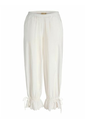 Weiße lockere Hose mit elastischem Bund und mit Spitzenrüschen an den Bündchen, die an den Knöcheln mit kleinen Schleifen gebunden sind.