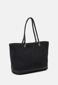 Black suede tote bag with double leather handles and silver metal ring attachments, shown at a slight angle on white background.