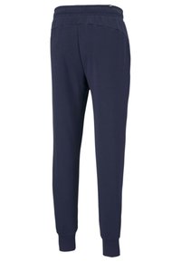 Marina joggingsbyxor gjorda av mjukt tyg, med en elastisk midja, smalnande ben och ribbade muddar. Inga synliga mönster eller hårdvara.