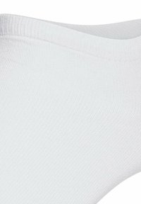 Chaussettes blanches à la cheville avec un bord côtelé et une texture lisse, présentant un design sans couture et un tissu léger pour le confort.