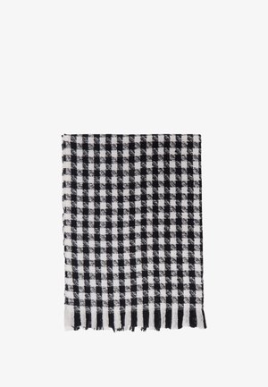 Black and white checkered towel with frayed edges, made of textured fabric, featuring a grid pattern of alternating squares.