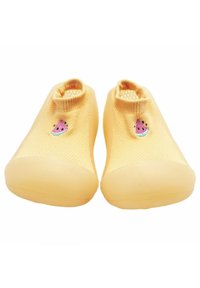 Zapatos de slip-on amarillos de punto con parte superior texturizada, que presentan un pequeño motivo de sandía bordado y una suela de goma lisa.