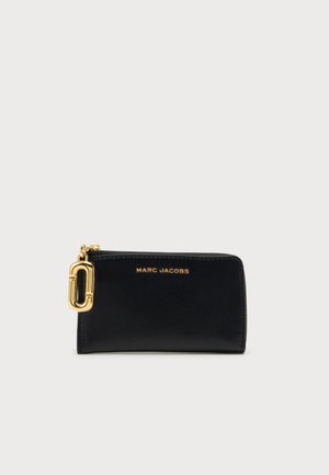 Portefeuille rectangulaire en cuir noir avec fermeture éclair dorée et logo "Marc Jacobs" en lettres dorées à l'avant.