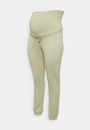 Calças de maternidade em verde claro, com uma cintura elástica larga, cordão ajustável, dois bolsos laterais e punhos elásticos.