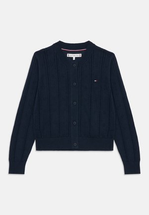 Marineblå strikket cardigan med knapper foran, ribstrikkede manchetter og kant samt lille Tommy Hilfiger-logo på brystet.