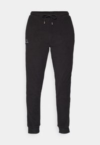 Zwarte joggingsbroek van zachte stof, met een elastische tailleband met trekkoord, taps toelopende pijpen en een klein logo aan de linkerkant.