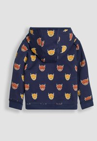 Felpa blu navy con cappuccio caratterizzata da volti di cartoni animati ripetuti con corna in arancione e giallo. Realizzata in tessuto morbido con una vestibilità comoda e polsini a coste.