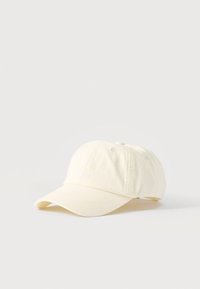 Λευκό καπέλο μπέιζμπολ από βαμβάκι με καμπυλωτό γείσο και διακριτικό κεντημένο κείμενο "CPH STUDIOS" μπροστά, εμφανισμένο σε λευκό φόντο.