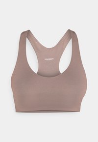 Brown, seamless sports bra with a racerback design. Made from stretch fabric, featuring a smooth texture and minimal branding on the back.