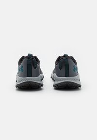 Grijze sportschoenen met een gemêleerde zool, versterkte hiel en teal accenten. Voorzien van een trekband aan de achterkant voor een gemakkelijke in-en-uit stap.