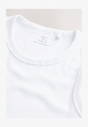 Débardeur blanc slim en tissu côtelé. Il présente un col rond, des détails cousus et une étiquette de marque située à l'intérieur du col.