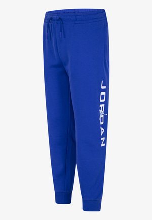 Blaue Jogginghose mit elastischem Bund, Kordelzug, Bündchen an den Knöcheln und weißem "JORDAN"-Schriftzug mit Jumpman-Logo am linken Bein.