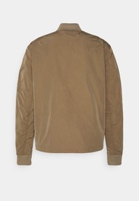 Brown, lightweight bomber jacket with a textured finish, ribbed collar and cuffs, and a simple, unadorned design on the back.