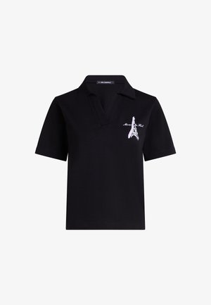 Svart polo tröja med klassisk krage, med en broderad design av Eiffeltornet i rosa på vänster bröstområde. Tillverkad av bomull.