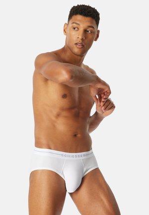 Slip da uomo bianchi con una morbida cintura elastica con il logo "SCHIESSER", tessuto liscio e design aderente che valorizza la forma e il comfort.