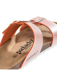 Infradito alla moda con tomaia sintetica rosa, soletta in sughero, suola in gomma bianca e dettaglio in metallo argentato sulla fibbia. Logo del marchio stampato sulla soletta.