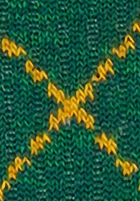 Tessuto di lana verde con motivo a zigzag giallo cucito al centro.