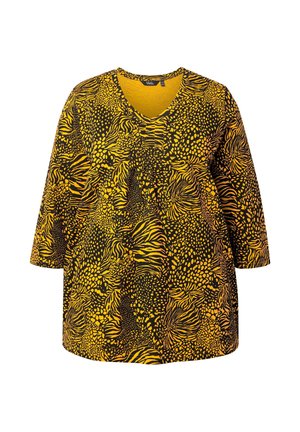 Yellow and black patterned top with a V-neck and three-quarter sleeves. Features an abstract animal print design and soft texture.