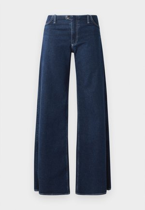 Jeans de pierna ancha en azul oscuro con costuras visibles, bolsillos delanteros y cierre de botón. Hechos de una tela de denim resistente.