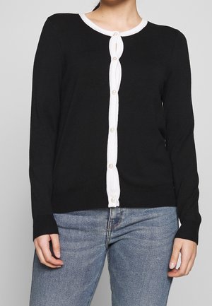 Cardigan lungo nero a maniche lunghe con placket e bordi bianchi. Realizzato in morbido tessuto a maglia, presenta un collo rotondo e polsini a costine.