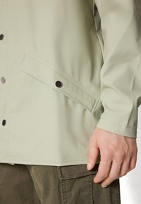 Rains JACKET UNISEX - Parka - earth