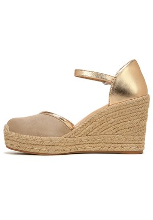 Wedge sandals with a beige fabric toe, gold metallic accents, and a woven jute platform. Features an adjustable ankle strap.
