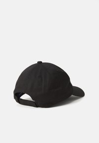 Black baseball cap made of cotton with a curved brim, adjustable strap at the back, and stitched detailing on the crown.