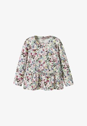 Top de manga larga con cuello redondo, que presenta un estampado floral en varios colores sobre un fondo claro, con un dobladillo con volantes.